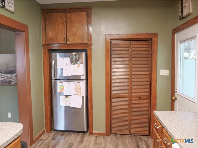 a view of a livingroom with wooden floor and a window