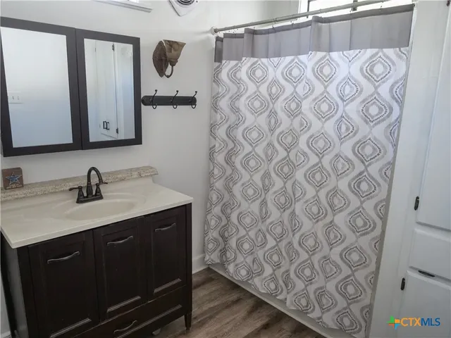 a living room with furniture a flat screen tv and wooden floor