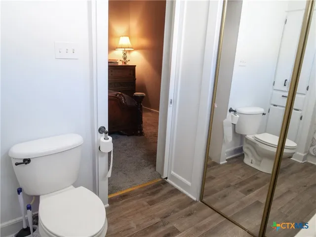 a view of a workspace with furniture and wooden floor
