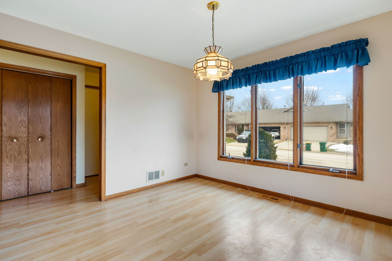 801 Eagle Creek Road Elwood, IL 60421 - Photo 4 of 17 a view of an empty room with a window and wooden floor