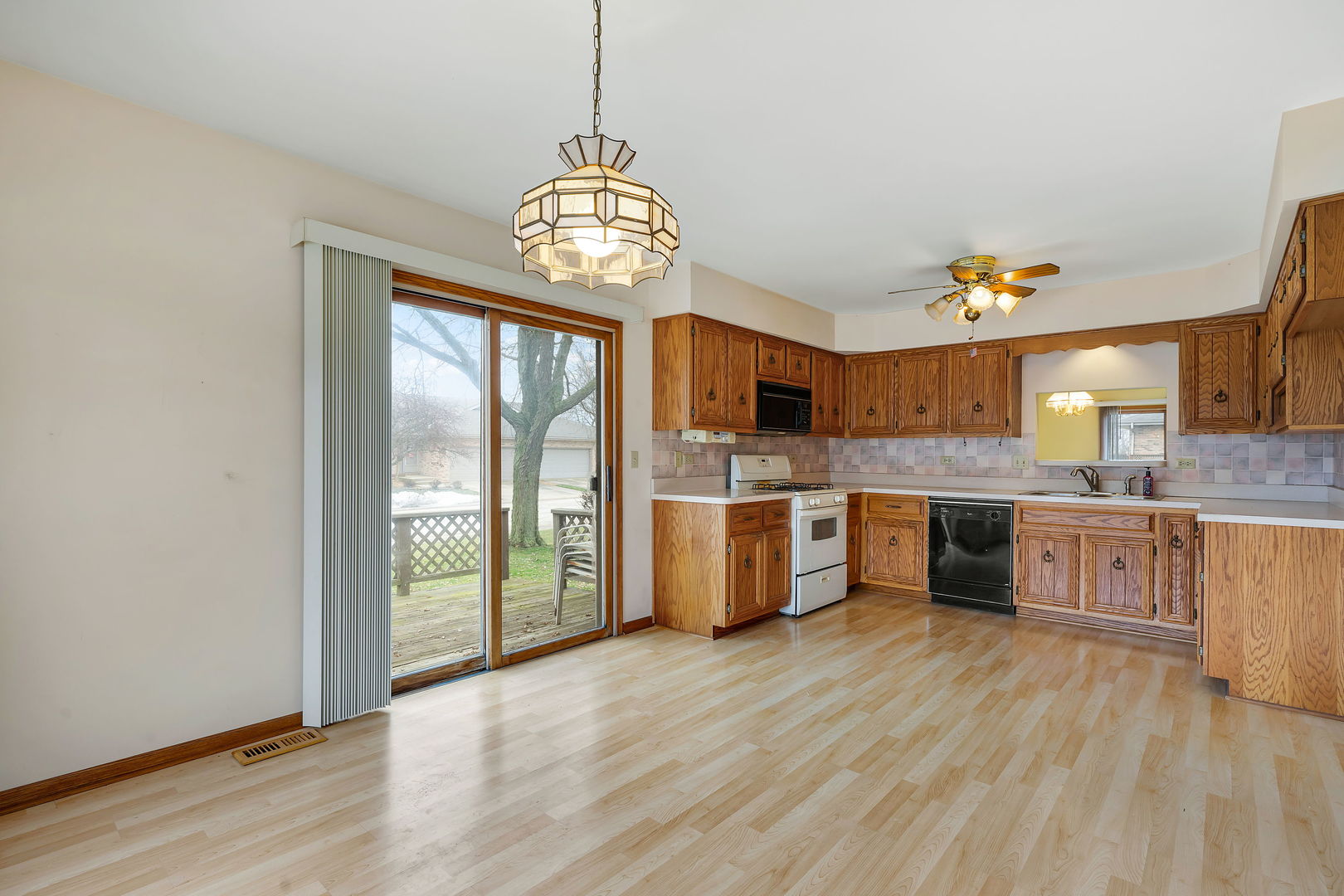 801 Eagle Creek Road Elwood, IL 60421 - Photo 5 of 17 a view of a kitchen center island wooden floor and a window