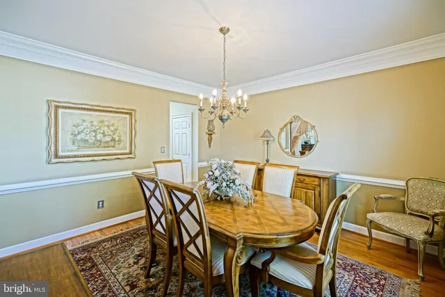 a large kitchen with kitchen island granite countertop a large window and stainless steel appliances