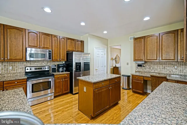 a living room with fireplace furniture and a chandelier