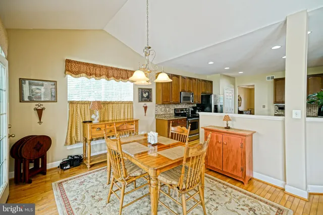 a bathroom with a granite countertop sink mirror vanity and toilet