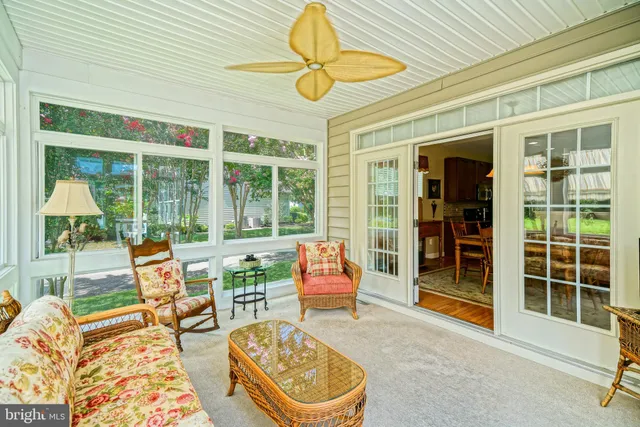 a living room with furniture a flat screen tv and a window