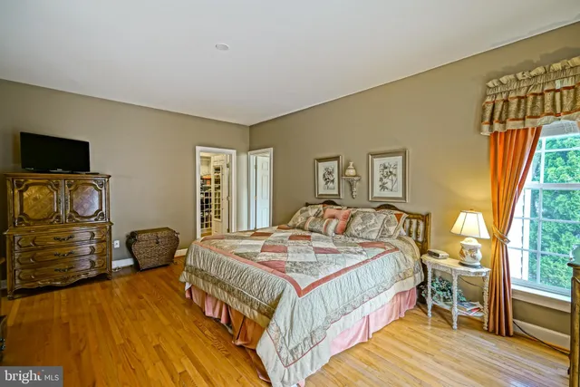 a bedroom with a large bed and a chandelier