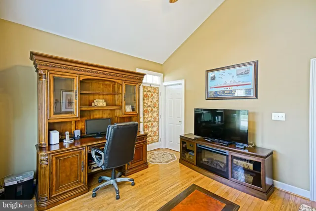 a backyard of a house with table and chairs under an umbrella