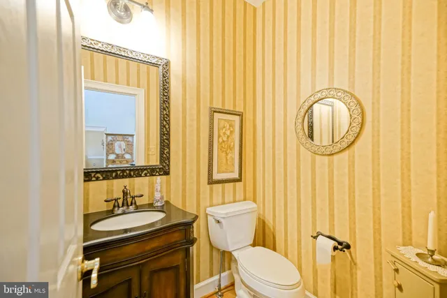 a backyard of a house with table and chairs under an umbrella