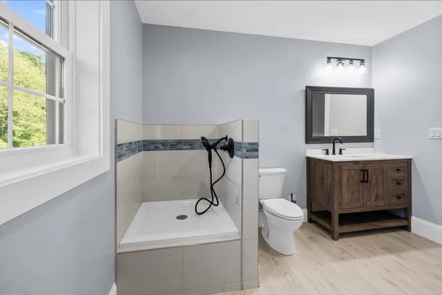 a bathroom with a toilet sink and mirror