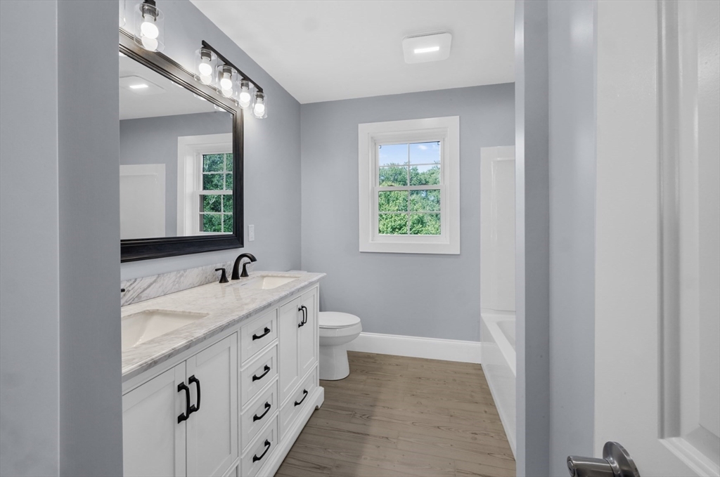 3 Morses Lane Acushnet, MA 02743 - Photo 30 of 42 a bathroom with a double vanity sink a mirror and a toilet