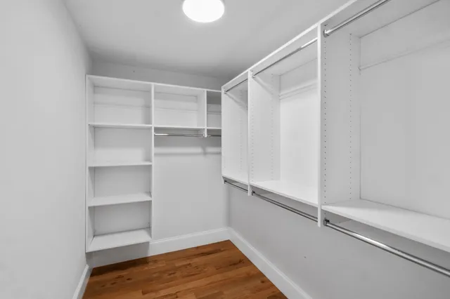 a view of walk in closet with empty racks