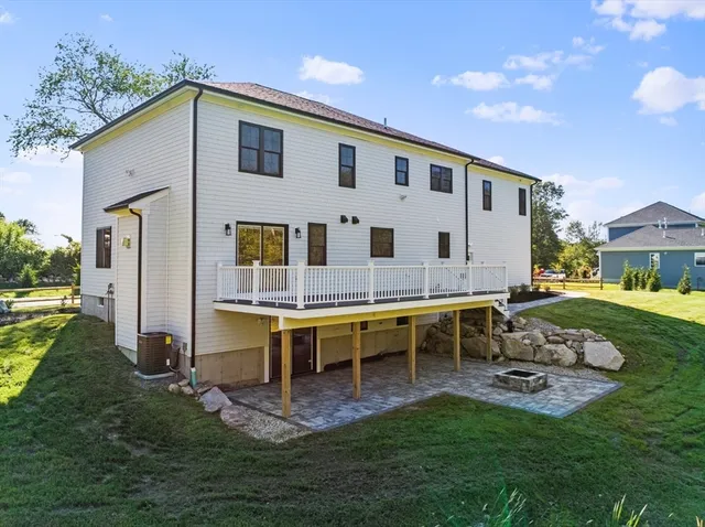 a swimming pool with outdoor seating and yard