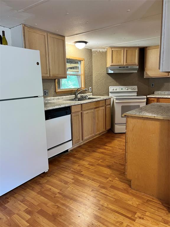 2334 San Bar Road, Unit 46 Graford, TX 76449 - Photo 10 of 37 a kitchen with granite countertop a refrigerator stove top oven and sink