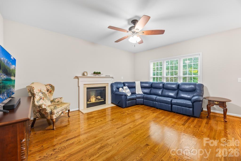 17028 Hampton Trace Road Huntersville, NC 28078 - Photo 7 of 41 a living room with furniture and a fireplace