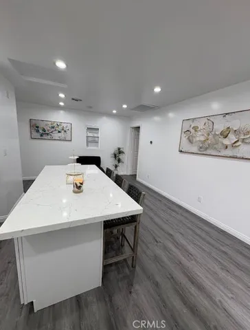 a view of a room with wooden floor