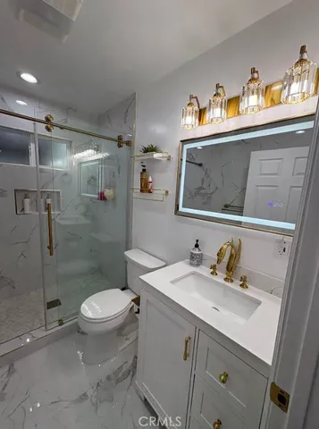 a bathroom with a sink toilet and shower