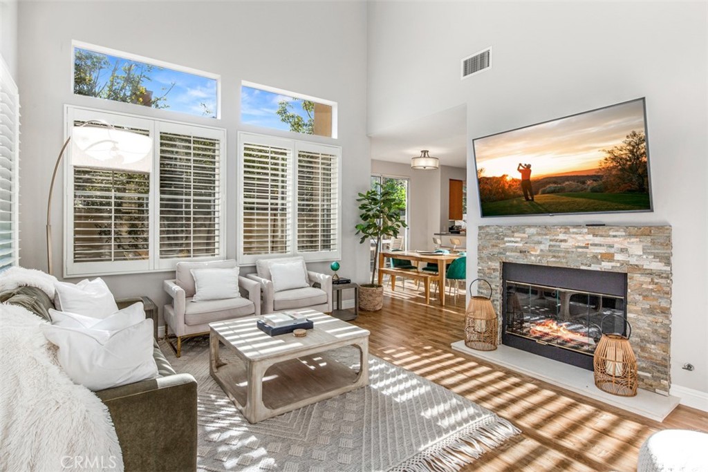 110 Lessay Newport Coast, CA 92657 - Photo 14 of 51 a living room with furniture a flat screen tv and a fireplace