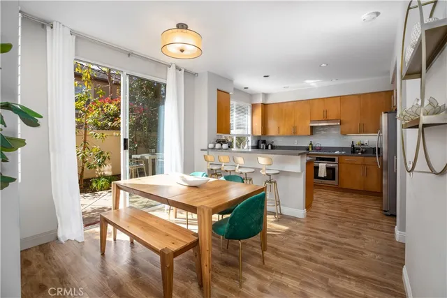a view of a dining room with furniture wooden floor and chandelier