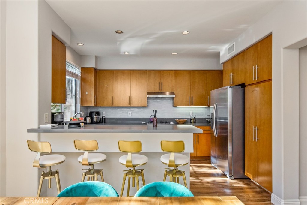 110 Lessay Newport Coast, CA 92657 - Photo 21 of 51 a kitchen with stainless steel appliances granite countertop a sink and a refrigerator