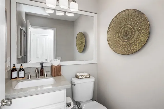 a bedroom with a large bed and a lamp