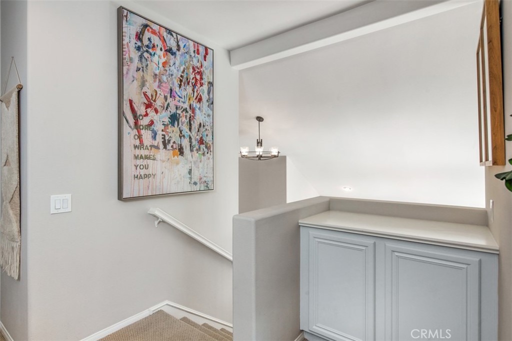 110 Lessay Newport Coast, CA 92657 - Photo 27 of 51 a view of a hallway with paintings on the wall