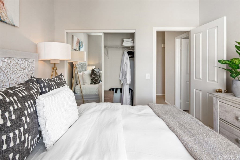 110 Lessay Newport Coast, CA 92657 - Photo 29 of 51 a bedroom with a large bed and a lamp