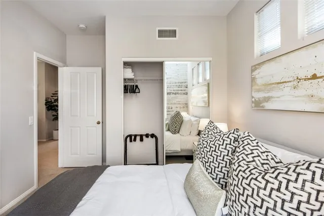 a spacious bedroom with a bed and a couch