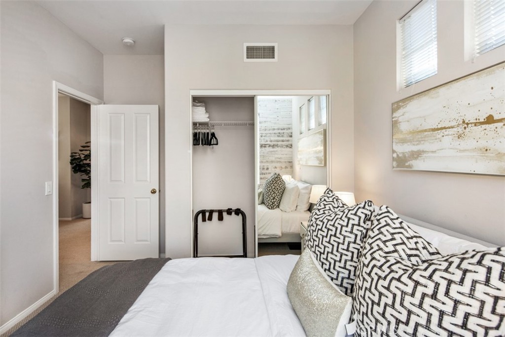 110 Lessay Newport Coast, CA 92657 - Photo 31 of 51 a bedroom with a bed and a painting on the wall