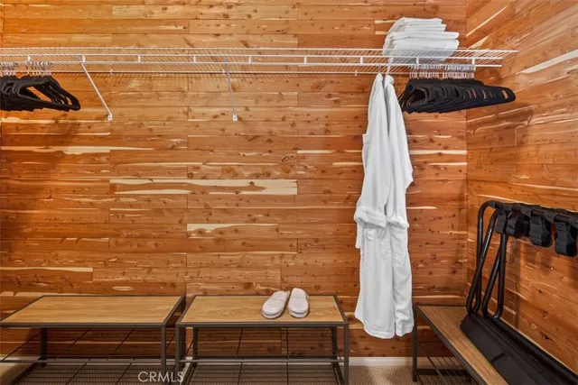 a large white bed sitting in a bedroom next to a window