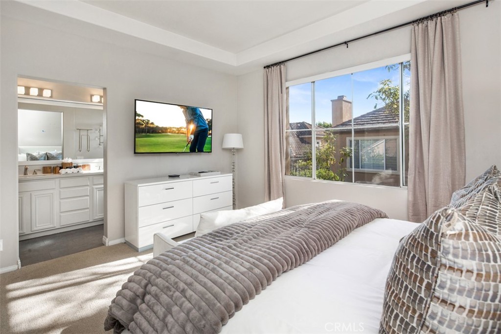 110 Lessay Newport Coast, CA 92657 - Photo 37 of 51 a bedroom with a bed and a flat screen tv