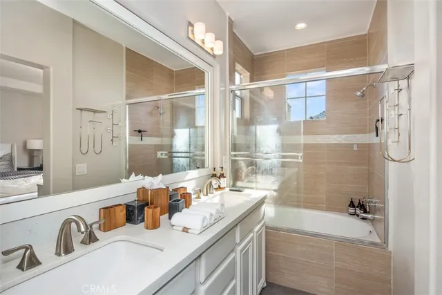 a backyard of a house with table and chairs and potted plants