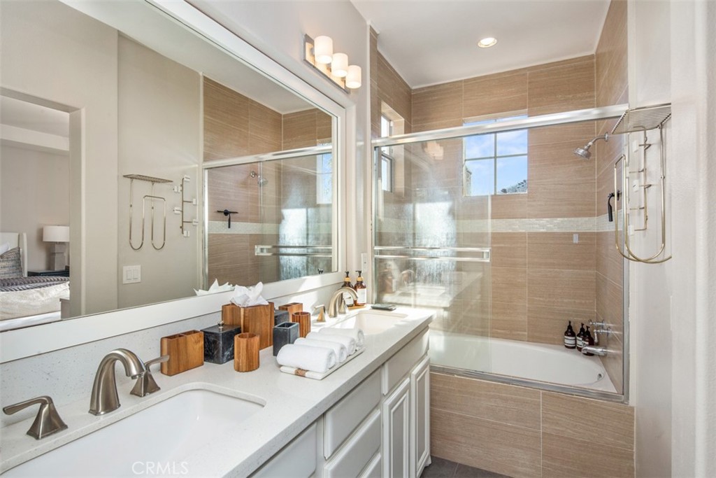 110 Lessay Newport Coast, CA 92657 - Photo 39 of 51 a bathroom with a tub sink double vanity granite tub shower and mirror