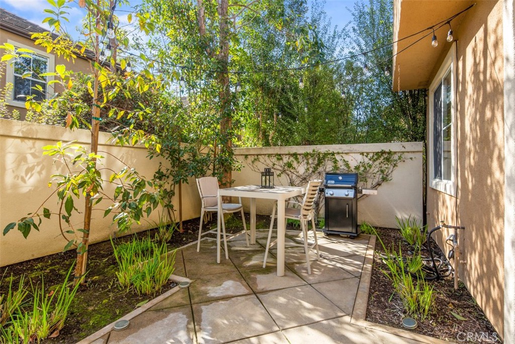 110 Lessay Newport Coast, CA 92657 - Photo 42 of 51 a view of a patio with table and chairs with wooden floor and fence