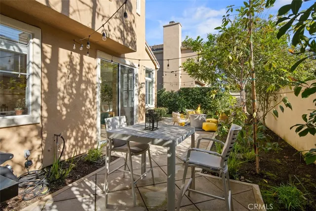 a backyard of a house with table and chairs