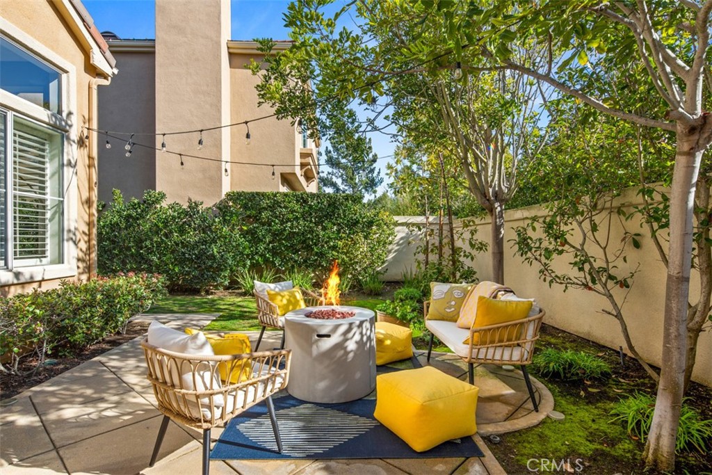 110 Lessay Newport Coast, CA 92657 - Photo 44 of 51 a backyard of a house with table and chairs and potted plants