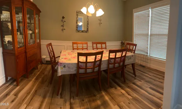 a view of a dining room with furniture and wooden floor