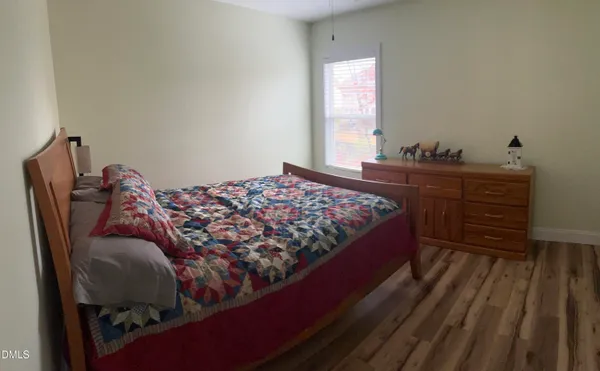 a bed sitting in a bedroom next to a window