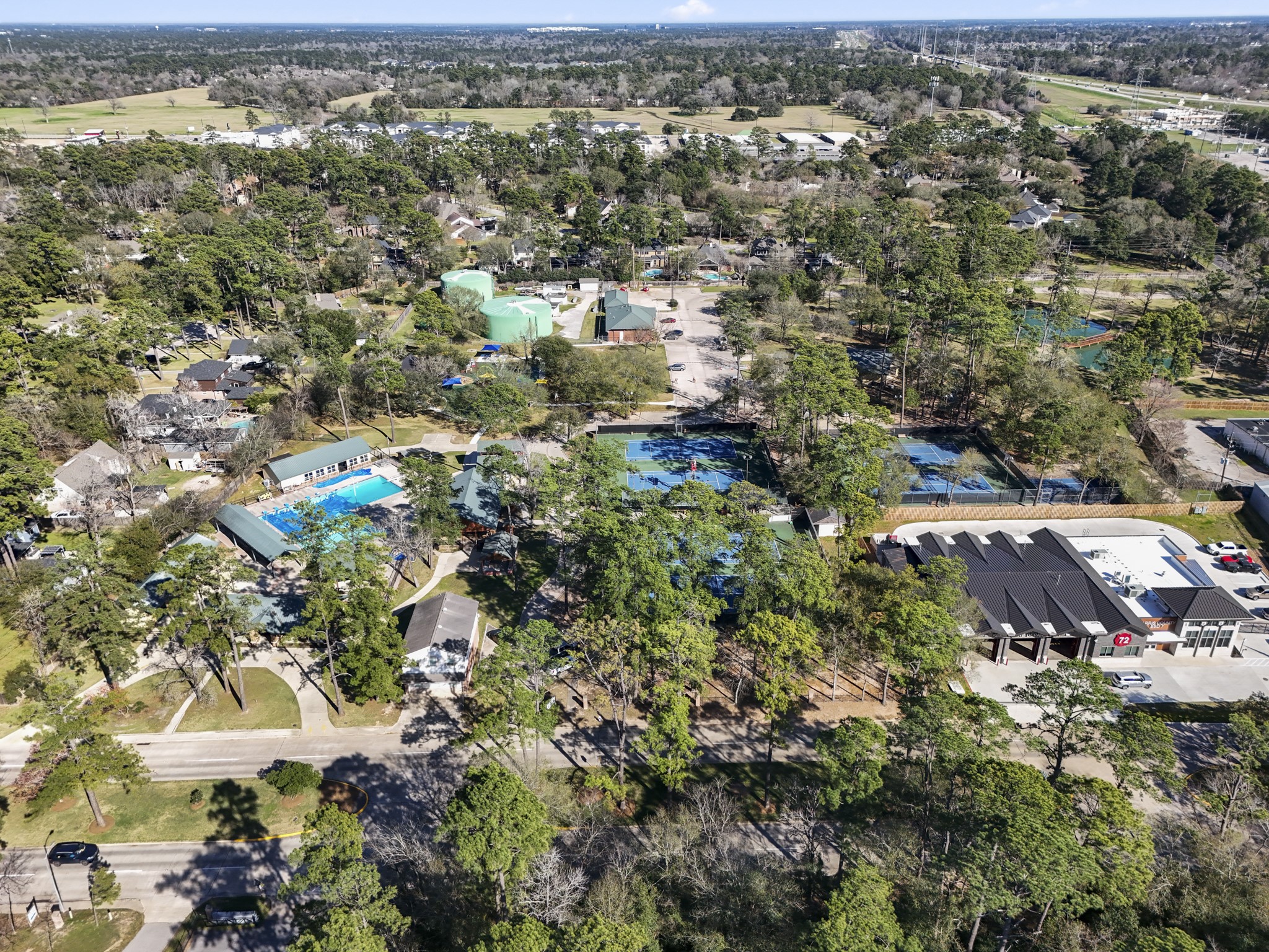 6303 Larkmount Drive Spring, TX 77389 - Photo 48 of 50 Zooming in on Northampton’s amenity area, the lifestyle piece of the neighborhood comes into view with recreation spaces, pool areas, and community gathering spots surrounded by the same established tree canopy seen throughout the area. It’s the kind of setting that adds to the appeal beyond the home itself, with parks, lakes, trails, playgrounds, and optional membership amenities all nearby.