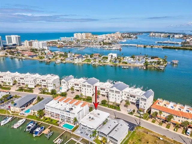an aerial view of a house with outdoor space lake view and ocean view