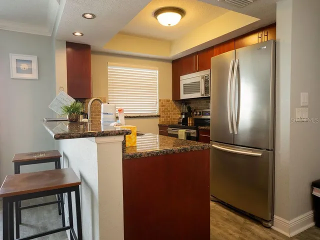 a kitchen with a refrigerator and a sink