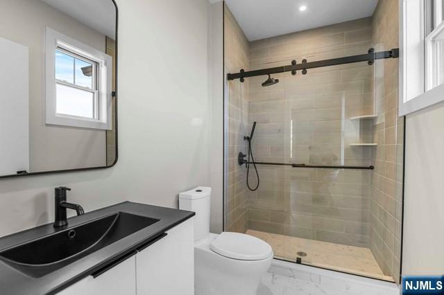 2021 Jones Road, Unit 203 Fort Lee, NJ 07024 - Photo 9 of 10 a bathroom with a sink a toilet and shower