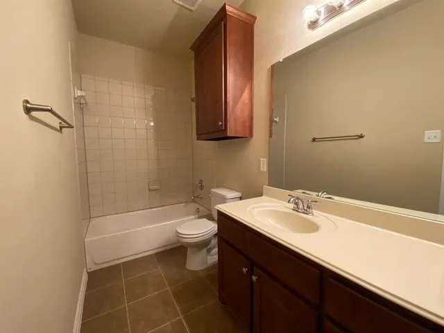 a bathroom with a toilet a sink and bathtub