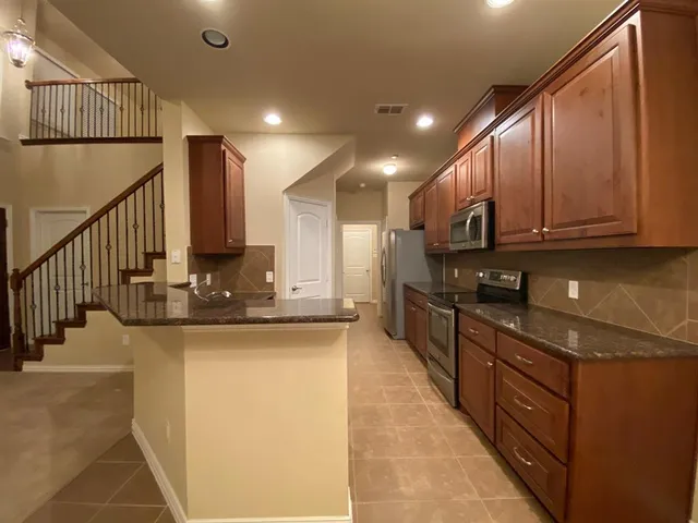 a kitchen with a sink and chandelier