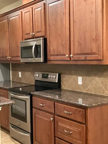 an empty room with wooden floor and white walls