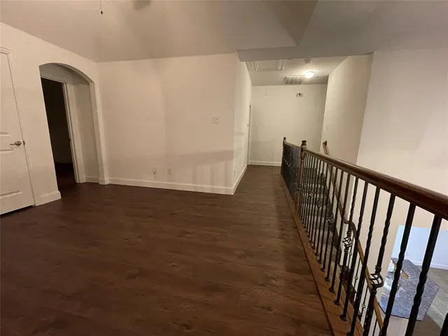an empty room with wooden floor and closet