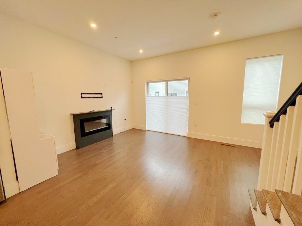 23 Charles Park Road, Unit 23 Boston, MA 02132 - Photo 11 of 35 a view of empty room with wooden floor
