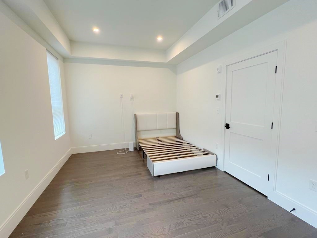 23 Charles Park Road, Unit 23 Boston, MA 02132 - Photo 19 of 35 wooden floor in an empty room with a window