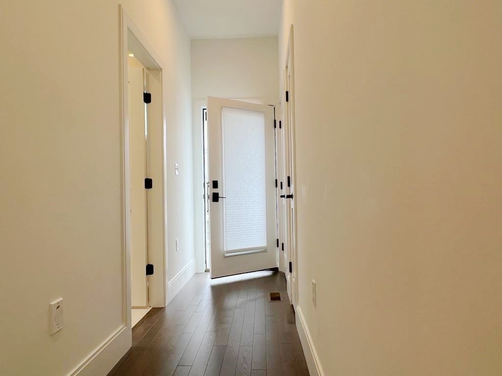 23 Charles Park Road, Unit 23 Boston, MA 02132 - Photo 30 of 35 a view of a hallway with wooden floor