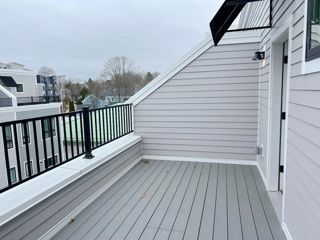 23 Charles Park Road, Unit 23 Boston, MA 02132 - Photo 32 of 35 a view of a balcony with wooden floor
