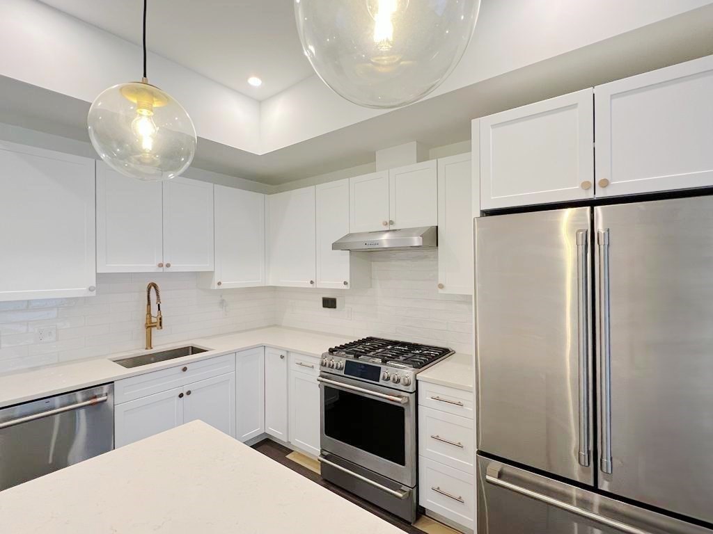 23 Charles Park Road, Unit 23 Boston, MA 02132 - Photo 5 of 35 a kitchen with stainless steel appliances a stove a sink and a refrigerator